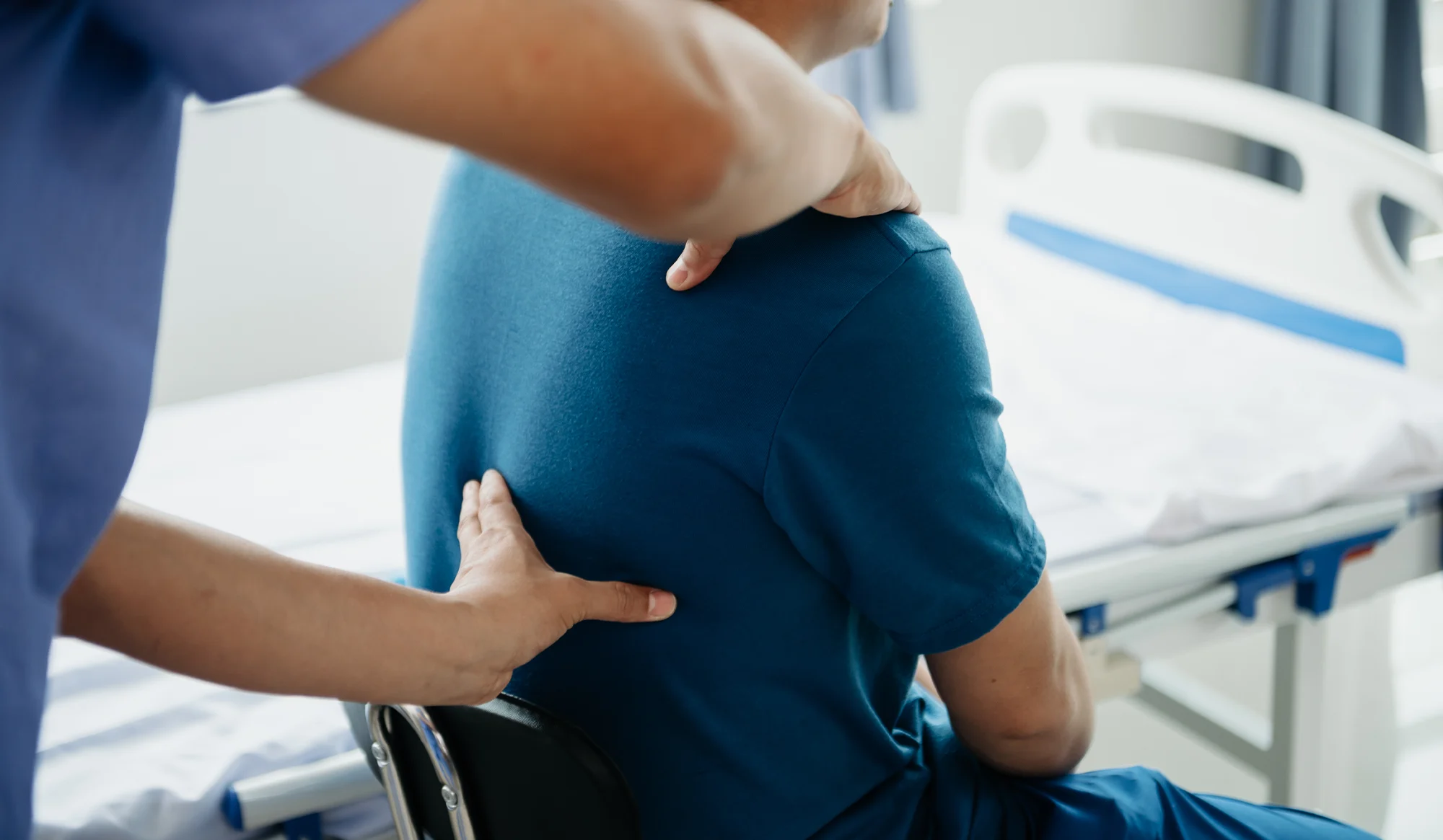 Chiropractor examining a patient's lower back