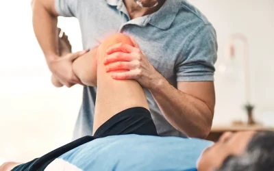 Chiropractor treating a patient's painful knee