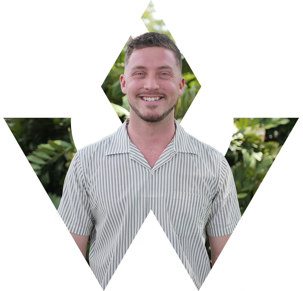 Dr. Jarod Ward smiling in a striped shirt