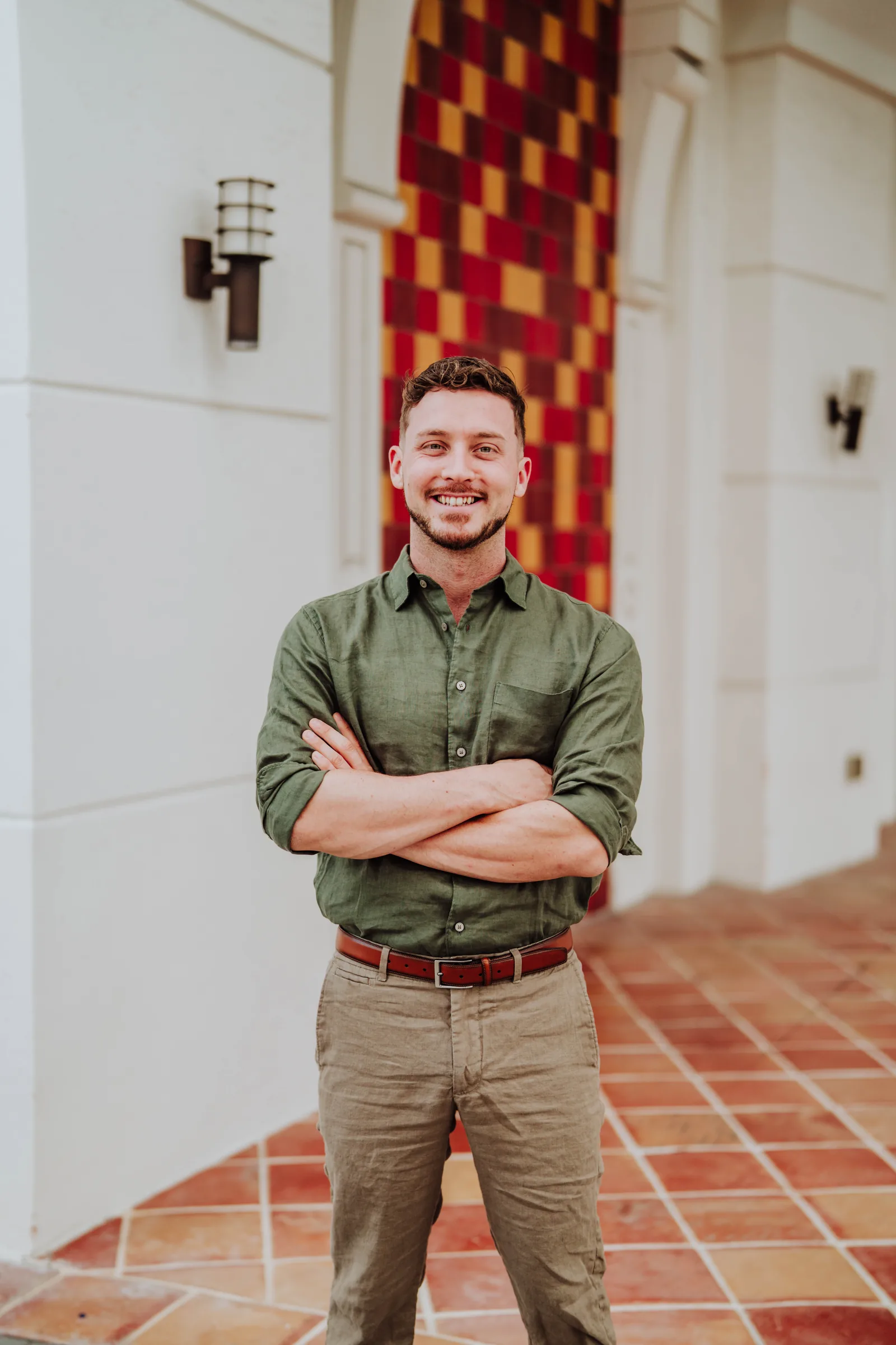 Dr. Jarod Ward with his arms crossed in front of a building entrance